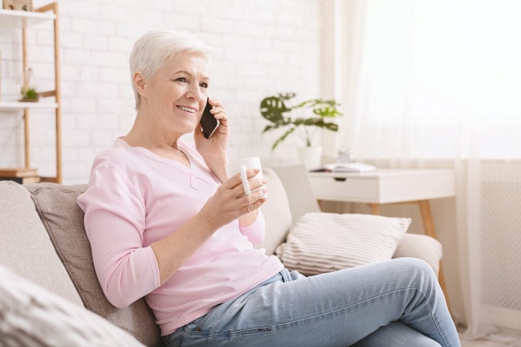 cheerful-senior-lady-having-phone-call-on-her-smar-P8QNGZ5