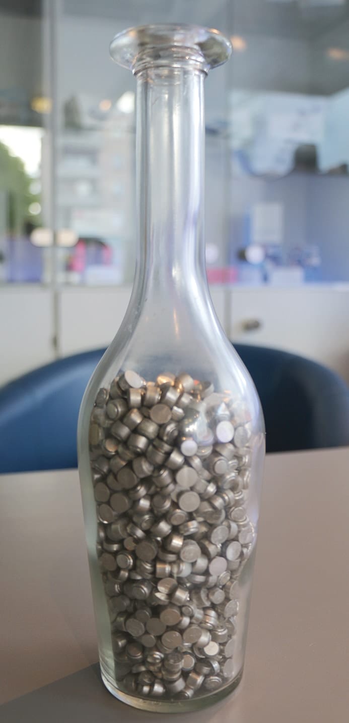 Bottle filled with used hearing aid batteries