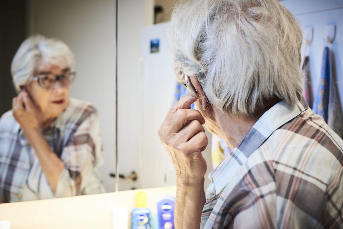Woman testing hearing aid